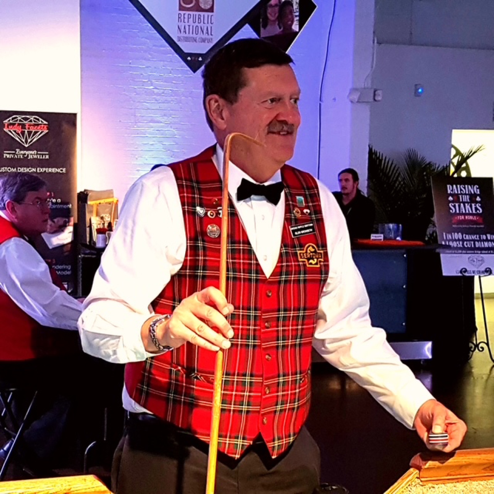 Sertoma volunteer in a tartan vest running the craps table